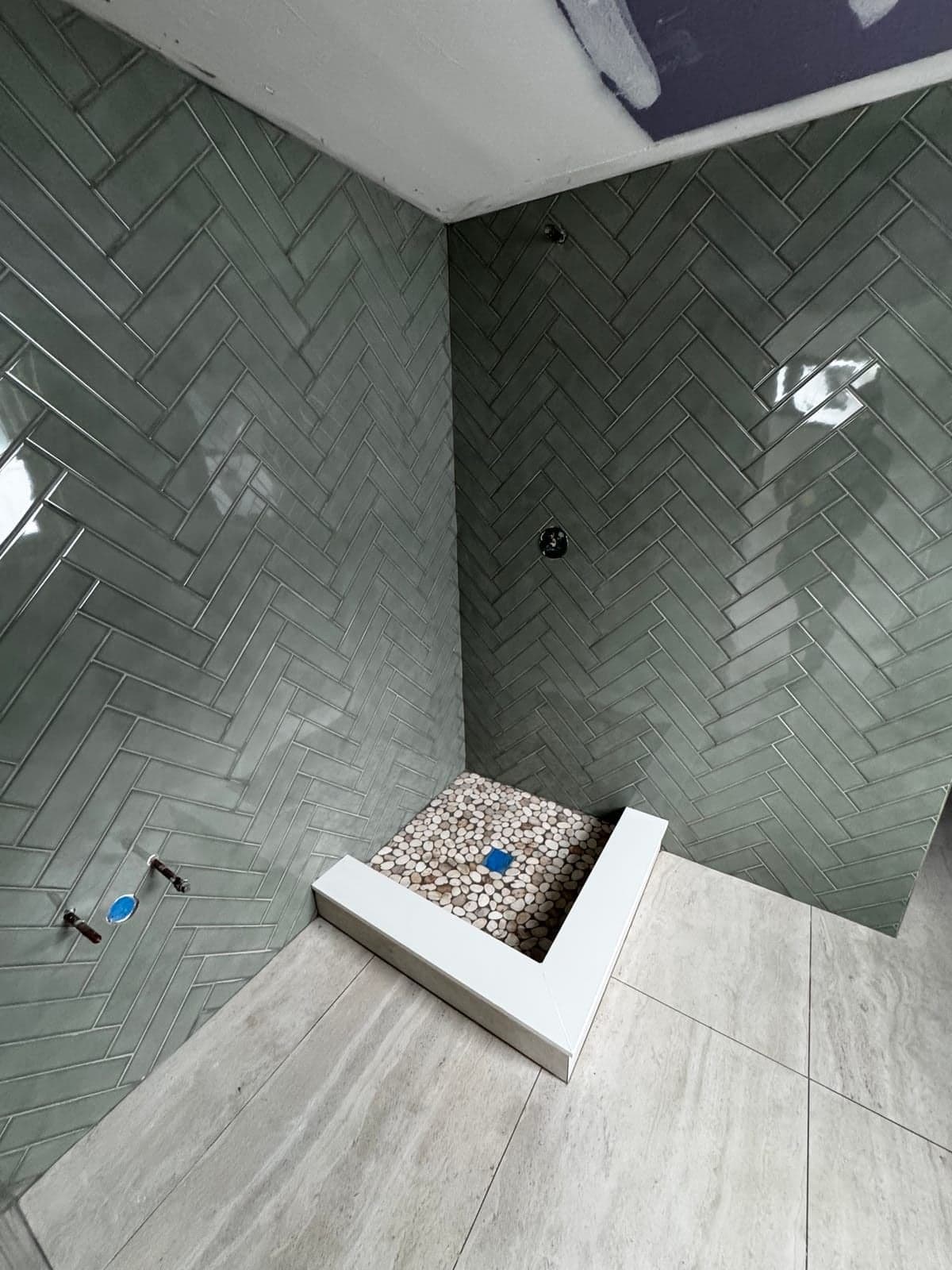 Herringbone tile shower with pebble floor in NJ