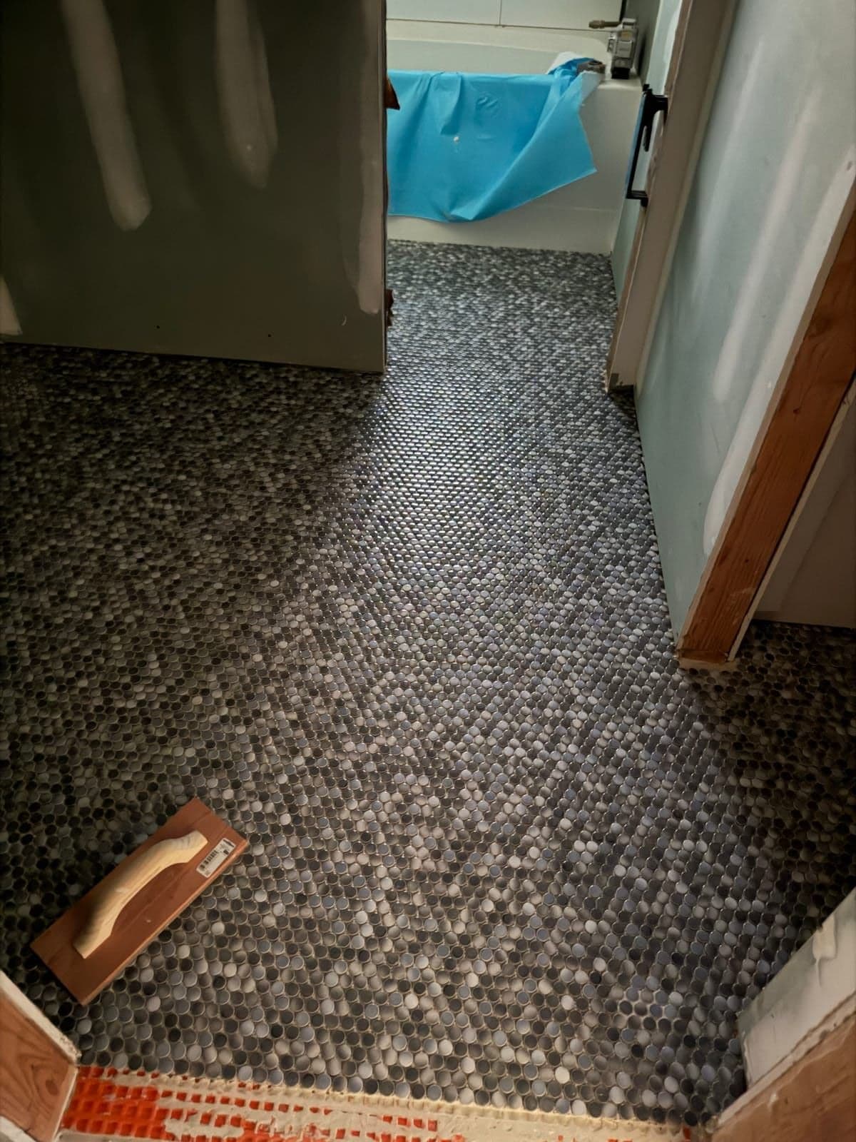 Hexagonal mosaic tile floor installation
