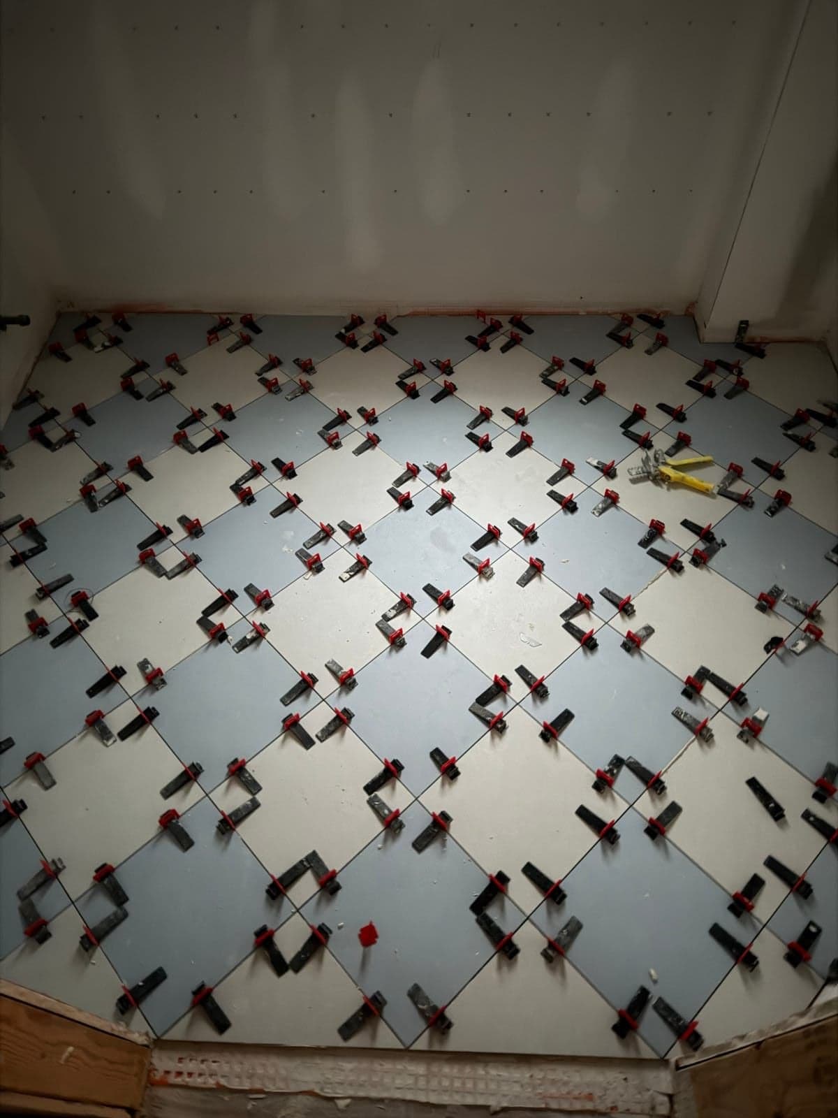 Diamond pattern floor tile installation